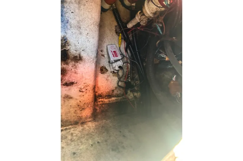Slide: The Image of Engine compartment of a 2000 Cape Horn 27XS boat, showing wiring and components. - 61