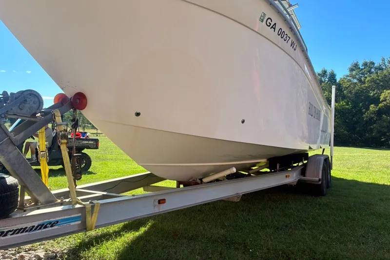 Slide: The Image of 2000 Cape Horn 27XS boat on trailer, grassy background, sunny day. - 6