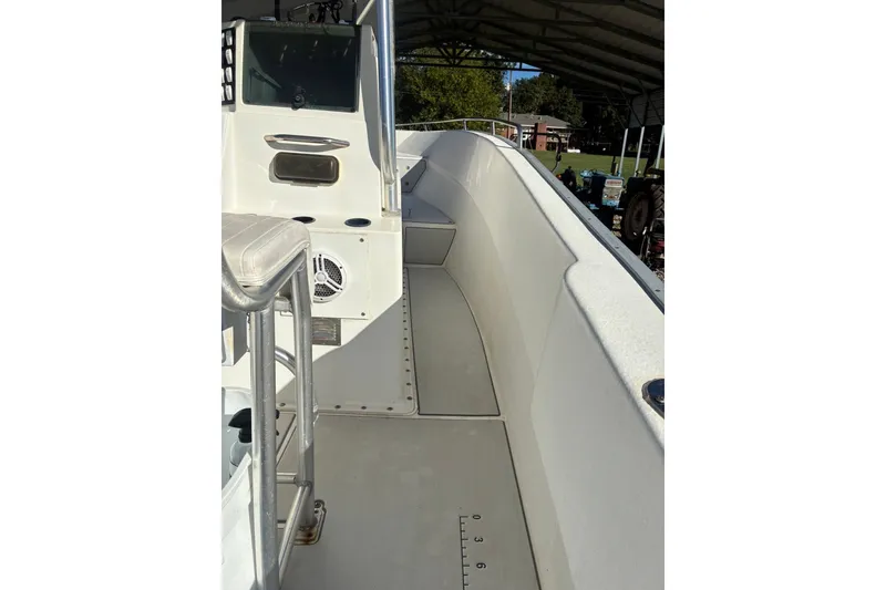 Slide: The Image of 2000 Cape Horn 27XS boat interior with seating and control panel under a canopy. - 41