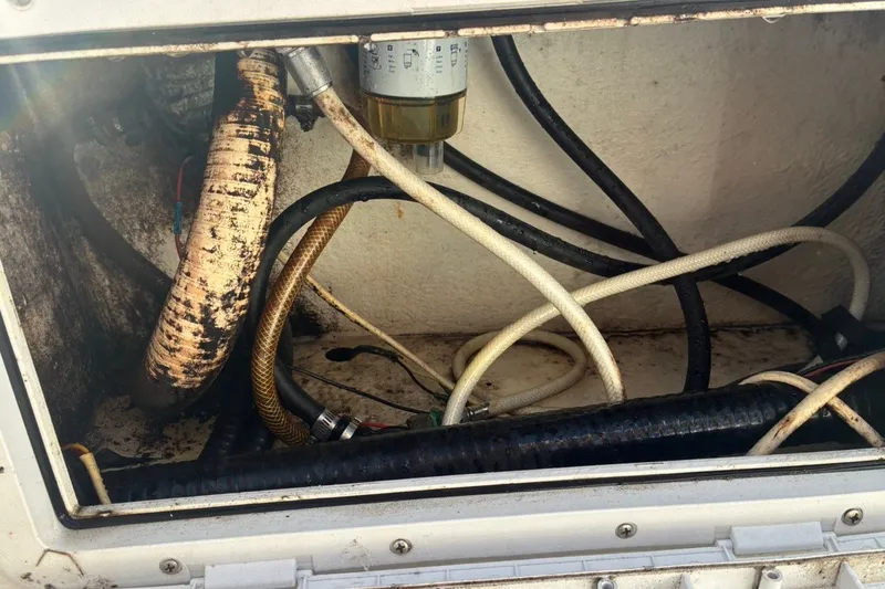 Slide: The Image of Boat engine compartment with hoses and filter, Cape Horn 27XS, 2000 model. - 63