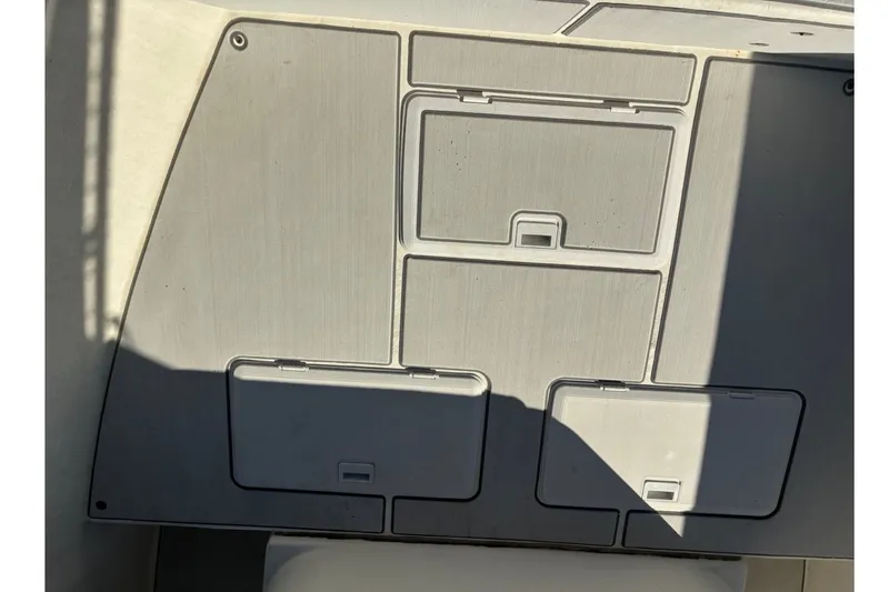 Slide: The Image of Deck storage compartments on a 2000 Cape Horn 27XS boat, featuring multiple hatches. - 30