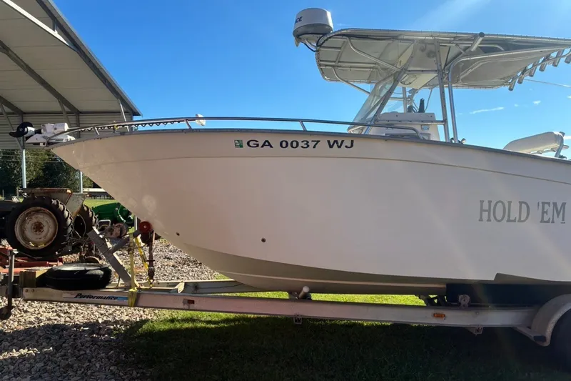 Slide: The Image of 2000 Cape Horn 27XS boat on trailer, side view, under a metal shelter. - 5