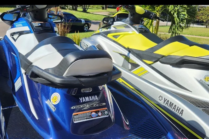 Slide: The Image of 2020 Yamaha WaveRunner VX Cruiser HO jet skis in blue and silver parked outdoors. - 2