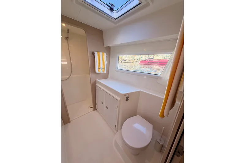 Slide: The Image of Modern bathroom in 2020 Lagoon 42 yacht with shower, toilet, and window view. - 95
