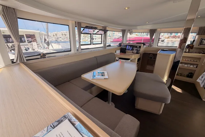Slide: The Image of Interior of 2020 Lagoon 42 catamaran with spacious seating and navigation equipment. - 78