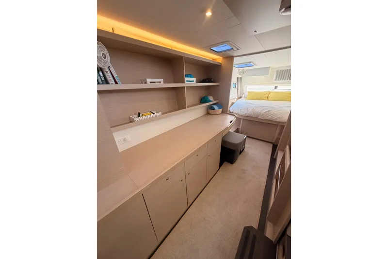 Slide: The Image of Luxurious interior of 2020 Lagoon 42 catamaran featuring a cozy bedroom and modern workspace. - 84