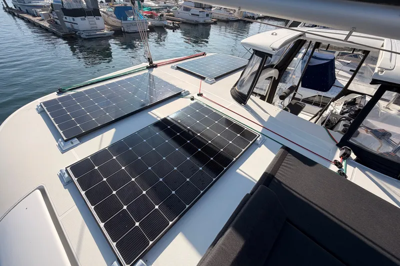 Slide: The Image of 2020 Lagoon 42 catamaran with solar panels on deck, docked at marina. - 45