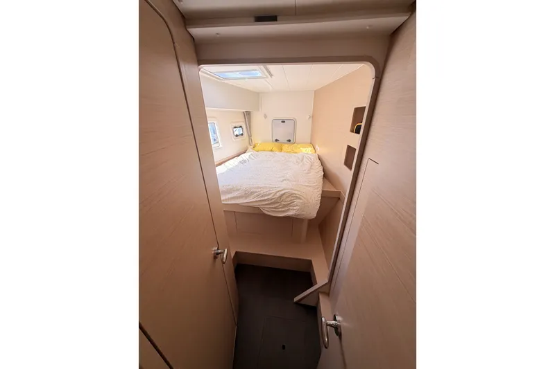 Slide: The Image of Interior cabin of 2020 Lagoon 42 catamaran with cozy bed and natural light. - 70