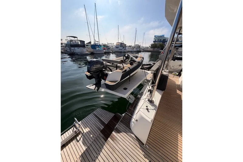 Slide: The Image of 2020 Lagoon 42 catamaran docked with Yamaha motorboat, marina view. - 26