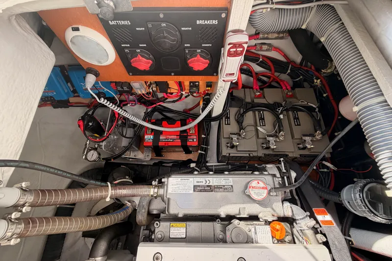 Slide: The Image of Engine compartment of a 2020 Lagoon 42 catamaran, showcasing batteries and wiring. - 105