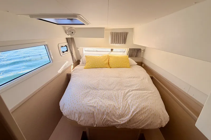 Slide: The Image of Cozy bedroom interior of 2020 Lagoon 42 catamaran with ocean view windows. - 88
