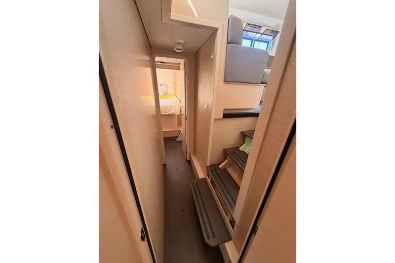Slide: The Image of Interior hallway of 2020 Lagoon 42 catamaran, featuring modern design and cozy cabin access. - 69