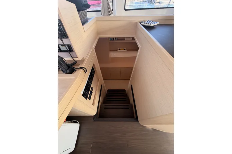 Slide: The Image of Interior view of 2020 Lagoon 42 yacht, featuring wooden stairs and modern design elements. - 82