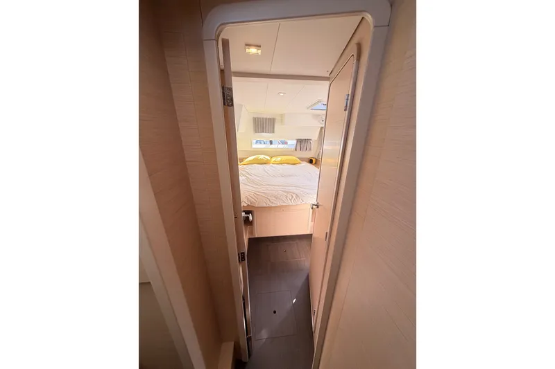 Slide: The Image of Interior cabin view of 2020 Lagoon 42 catamaran, featuring cozy bed and modern design. - 61