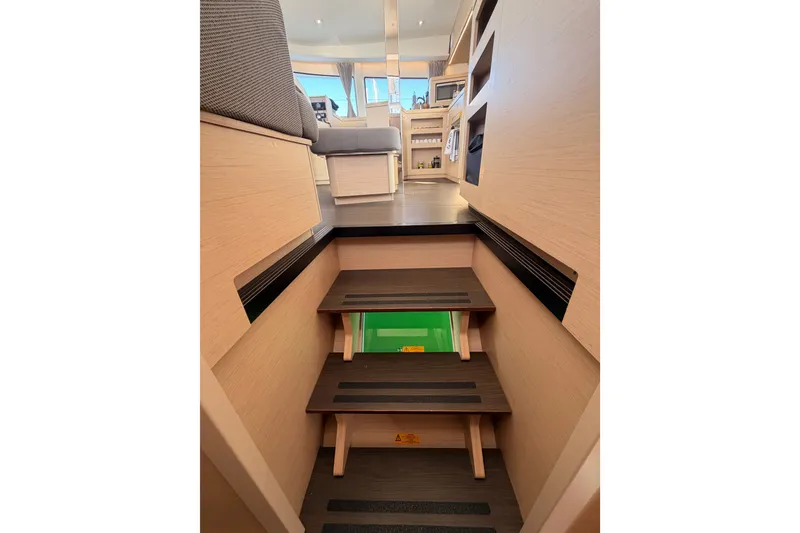 Slide: The Image of Interior view of 2020 Lagoon 42 yacht, featuring wooden stairs and modern furnishings. - 75