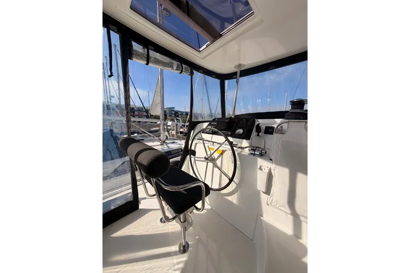 Slide: The Image of Helm station of 2020 Lagoon 42 catamaran with modern controls and panoramic views. - 34