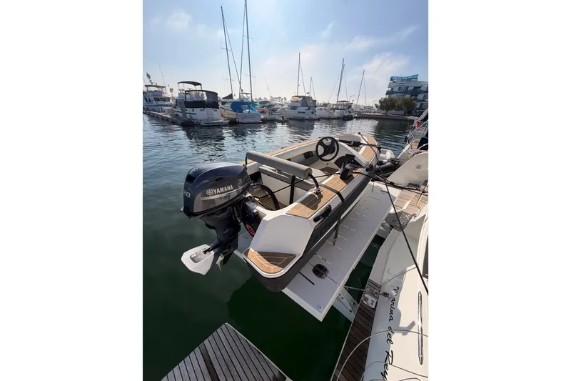 Slide: The Image of A 2020 Lagoon 42 yacht docked with a Yamaha outboard motor in a marina. - 29