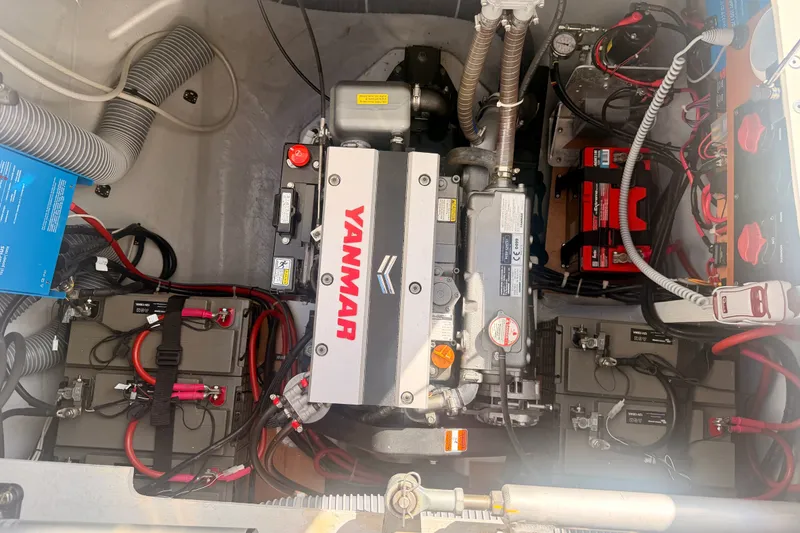 Slide: The Image of Engine compartment of a 2020 Lagoon 42 catamaran featuring a Yanmar engine and battery setup. - 103