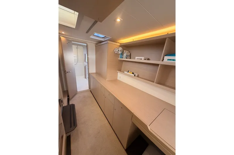Slide: The Image of Interior of 2020 Lagoon 42 yacht with modern cabinetry and shelving. - 92