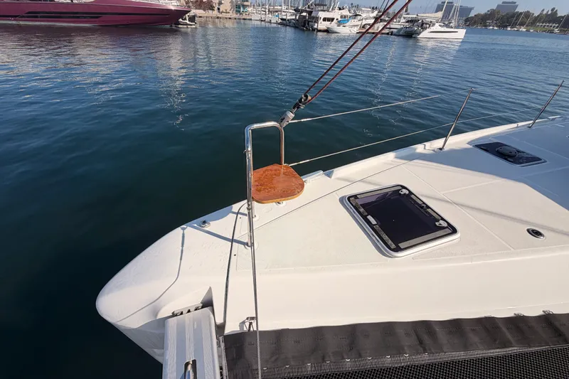 Slide: The Image of 2020 Lagoon 42 catamaran docked at marina, featuring sleek deck design. - 19