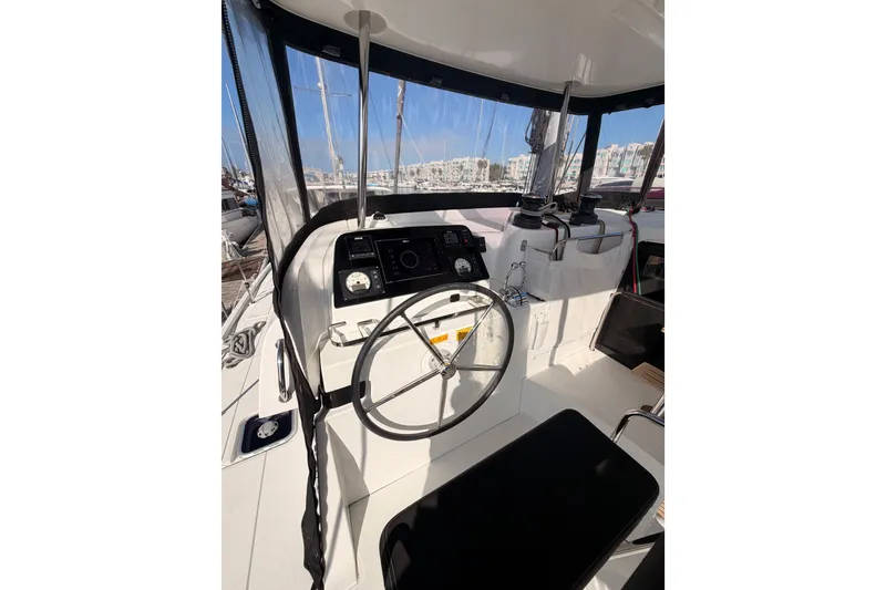 Slide: The Image of Cockpit of 2020 Lagoon 42 catamaran with steering wheel and navigation instruments. - 13