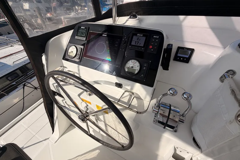 Slide: The Image of Cockpit of 2020 Lagoon 42 catamaran with navigation instruments and steering wheel. - 36