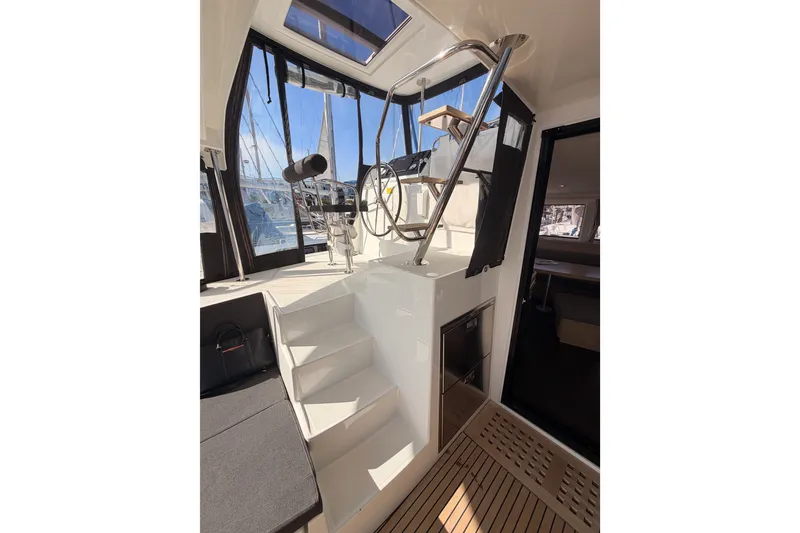 Slide: The Image of Interior view of a 2020 Lagoon 42 catamaran, featuring stairs and helm station. - 33