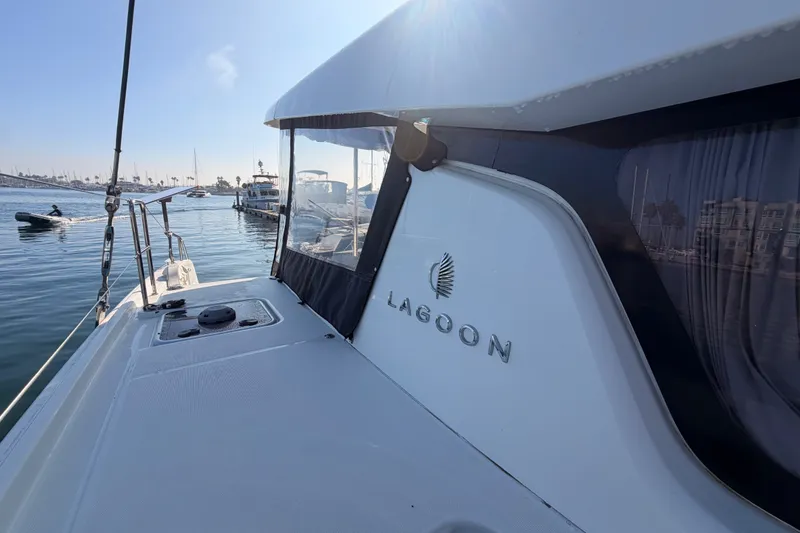 Slide: The Image of Lagoon 42 catamaran from 2020 docked at a marina under clear skies. - 24