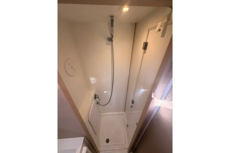 Slide: The Image of Compact shower area in a 2020 Lagoon 42 yacht, featuring modern fixtures and lighting. - 67