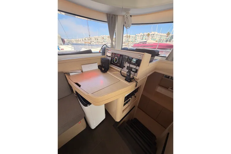 Slide: The Image of Interior helm station of 2020 Lagoon 42 catamaran with navigation equipment and marina view. - 79