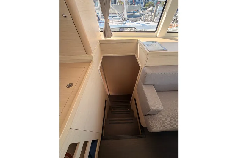 Slide: The Image of Interior view of a 2020 Lagoon 42 yacht, featuring stairs and modern furnishings. - 59