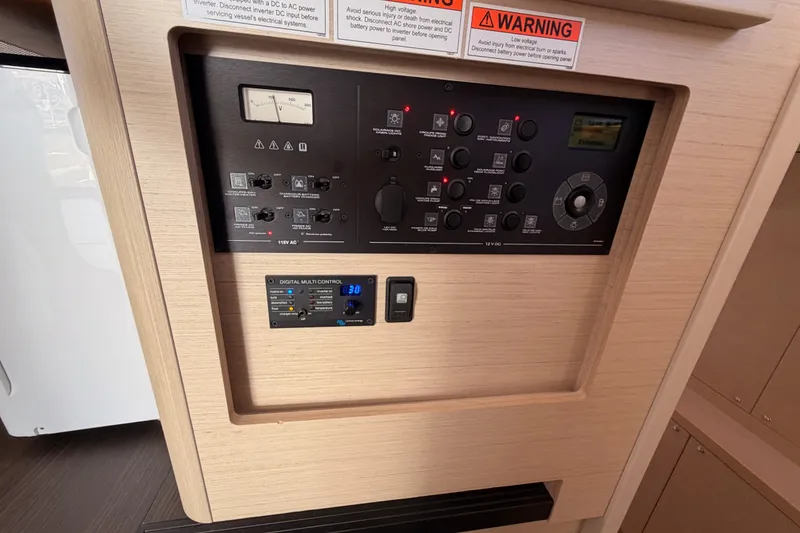 Slide: The Image of Control panel of a 2020 Lagoon 42 yacht with warning labels and digital display. - 81