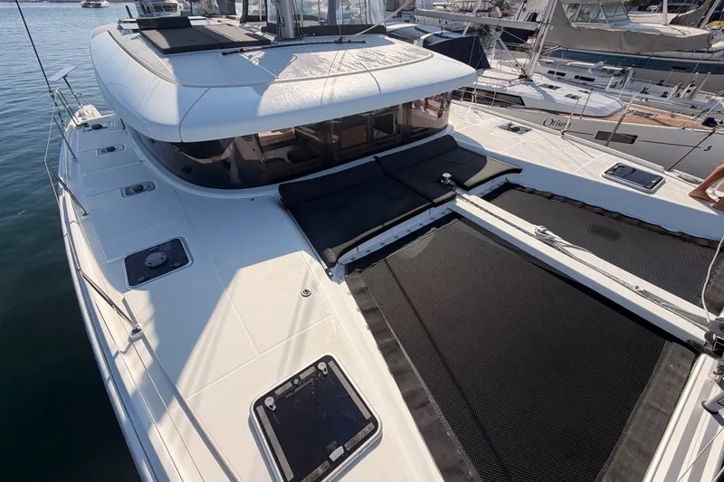 Slide: The Image of 2020 Lagoon 42 catamaran with spacious deck and modern design, docked at marina. - 21