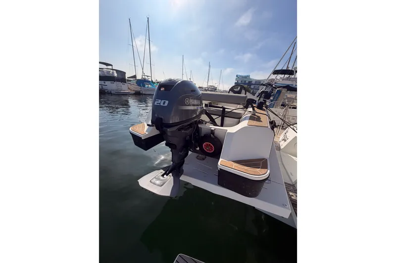 Slide: The Image of 2020 Lagoon 42 catamaran with Yamaha 20 outboard motor in marina setting. - 113