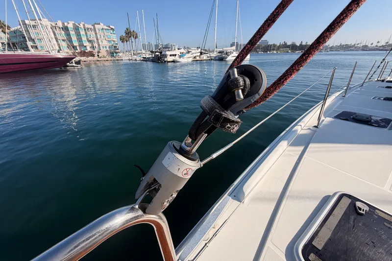 Slide: The Image of Lagoon 42 catamaran docked in marina, showcasing rigging and deck details, 2020 model. - 20