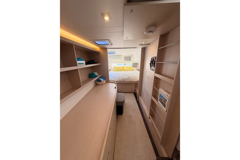 Slide: The Image of Interior of 2020 Lagoon 42 yacht, featuring a cozy bedroom with modern furnishings. - 85