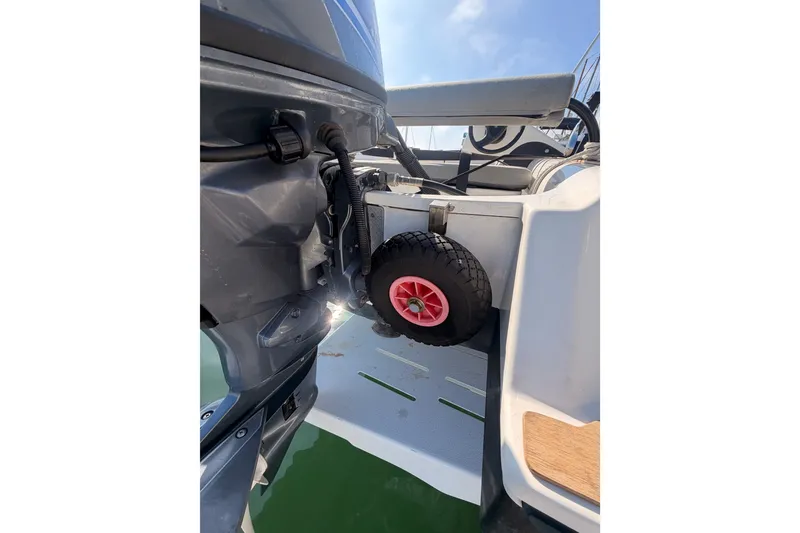 Slide: The Image of Outboard motor and wheel on 2020 Lagoon 42 catamaran, docked in sunny marina. - 114