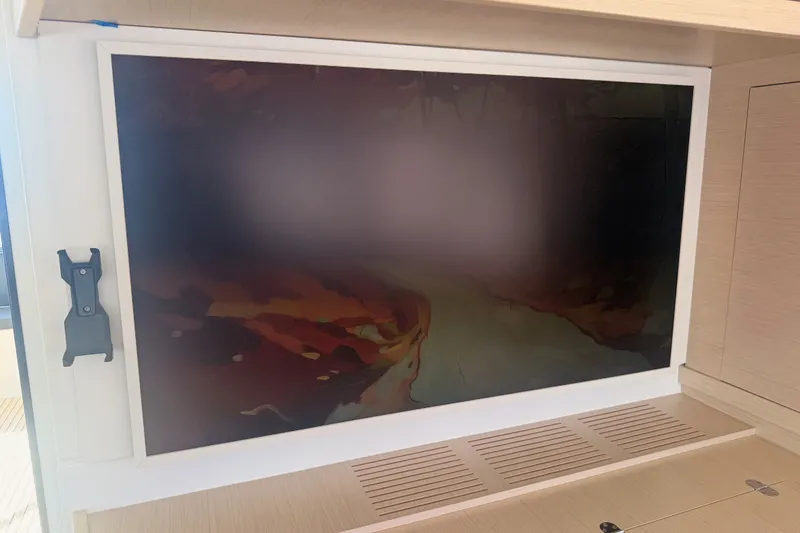 Slide: The Image of Interior of a 2020 Lagoon 42 yacht featuring a mounted screen. - 58