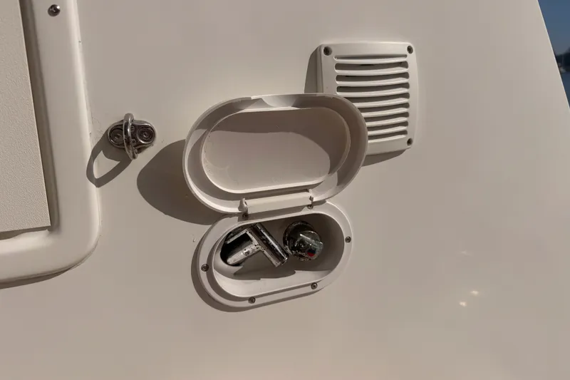 Slide: The Image of Open hatch on 2020 Lagoon 42 boat, revealing a water connection point. - 108