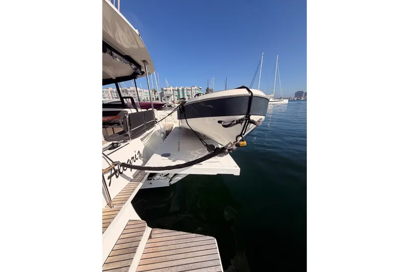 Slide: The Image of 2020 Lagoon 42 catamaran docked at marina with clear blue sky. - 9