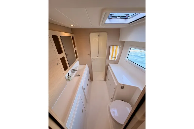Slide: The Image of Modern bathroom interior of 2020 Lagoon 42 yacht with shower, sink, and window view. - 93