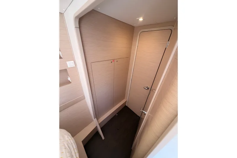 Slide: The Image of Interior of 2020 Lagoon 42 yacht, featuring sleek wooden paneling and modern design. - 74