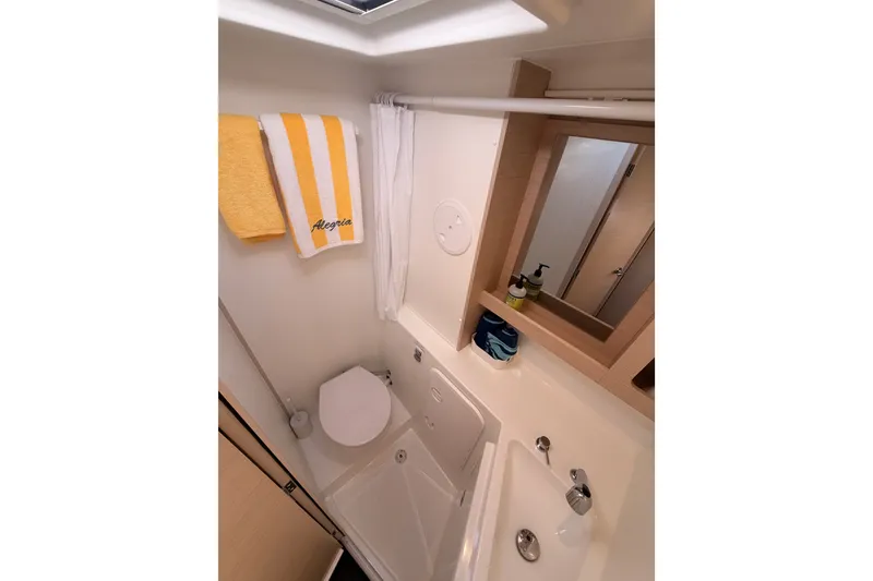 Slide: The Image of Bathroom interior of 2020 Lagoon 42 yacht with shower, sink, and mirror. - 73