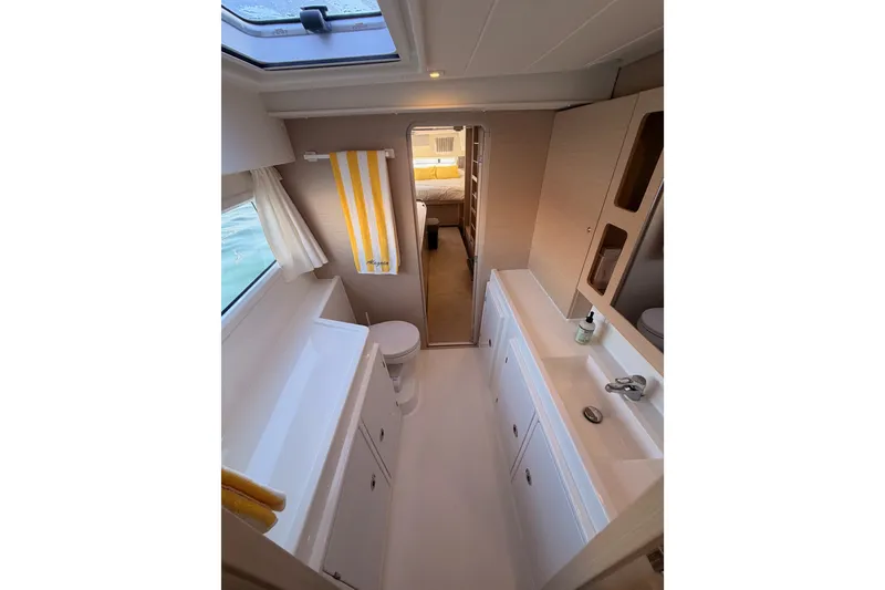Slide: The Image of Interior of 2020 Lagoon 42 yacht bathroom with modern fixtures and natural light. - 97