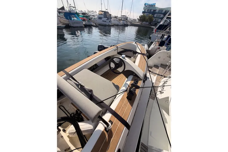 Slide: The Image of 2020 Lagoon 42 yacht docked at marina with wooden deck and steering wheel. - 116