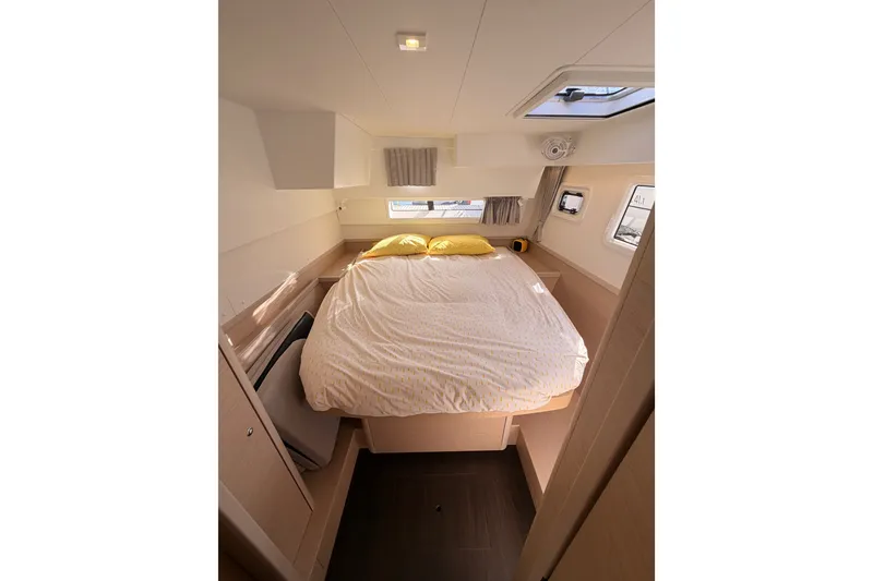 Slide: The Image of Interior cabin of 2020 Lagoon 42 catamaran with cozy bed and natural light. - 62