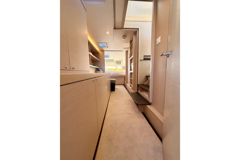 Slide: The Image of Interior of 2020 Lagoon 42 yacht, featuring modern cabinetry and cozy carpeted flooring. - 100