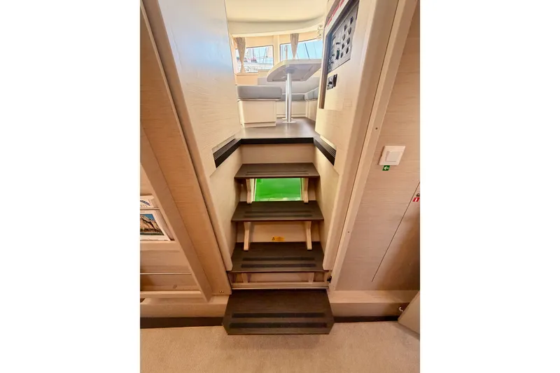 Slide: The Image of Interior stairs of 2020 Lagoon 42 catamaran, leading to a bright seating area. - 101