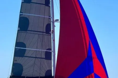 Slide: The Image of Sailing catamaran Lagoon 42, 2020 model, with vibrant red and blue sails. - 123