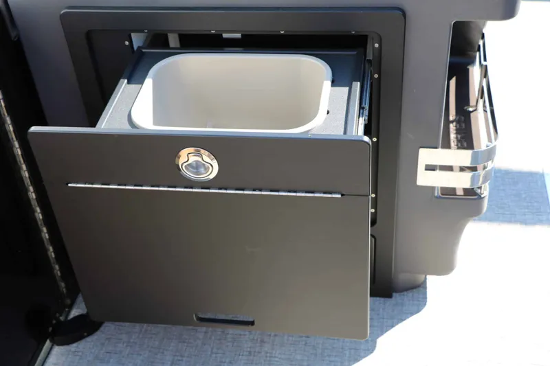 Slide: The Image of An open cabinet with a pull-out drawer containing a bin inside. - 46